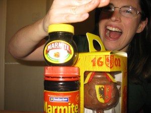 Qu'ainsi périssent les ennemis du Cenovis ! Fake Genevan karate-chopping two jars of different kinds of Marmite, while a Marmite de l'Escalade sits unharmed behind them.