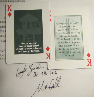 Kings of Diamonds reading 'You may be stopped and searched at any time' and 'Completed in 1937, in just over four years, the Golden Gate Bridge cost $35 million to build. Completed in 1930, in under one year, the Empire State Building cost just under $25 million to build.'