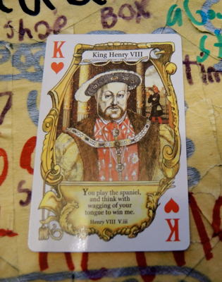 King of Hearts with the Shakespearean insult, 'You play the spaniel, and think with wagging your tongue to win me' against a backdrop of a Worm Quartet Songs of the Maniacs poster