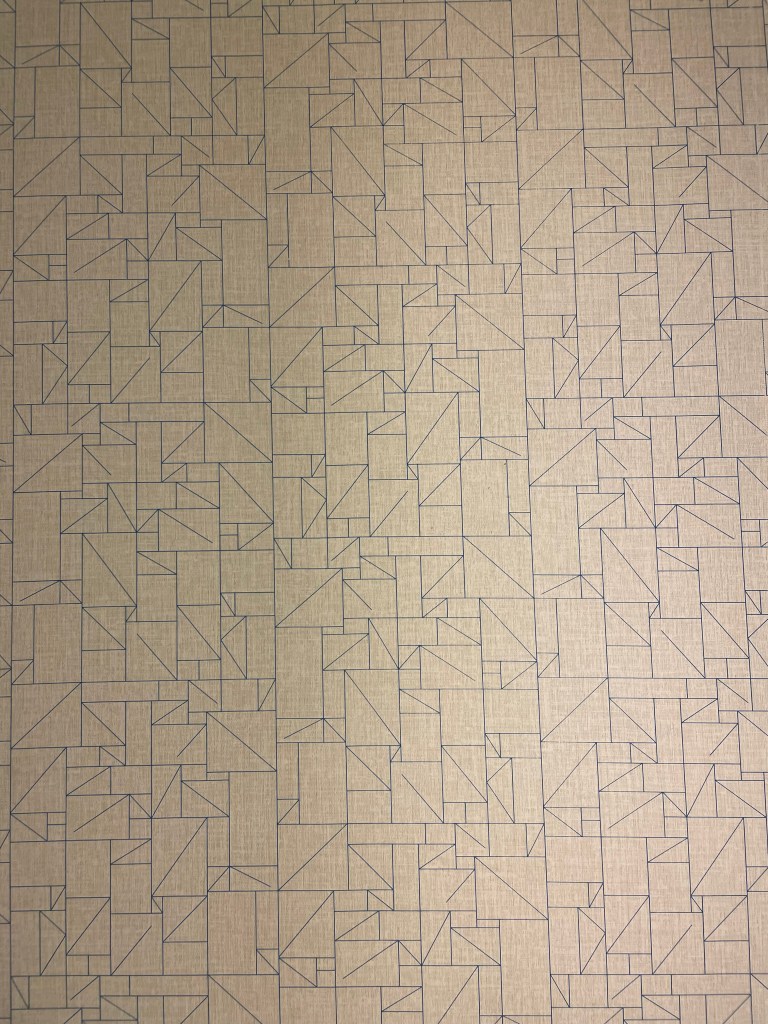 Off-white wallpaper with line art of a complicated pattern of various sizes of rectangles, some of which are divided into two triangles, and some of which have diagonal lines going only part of the way across them.