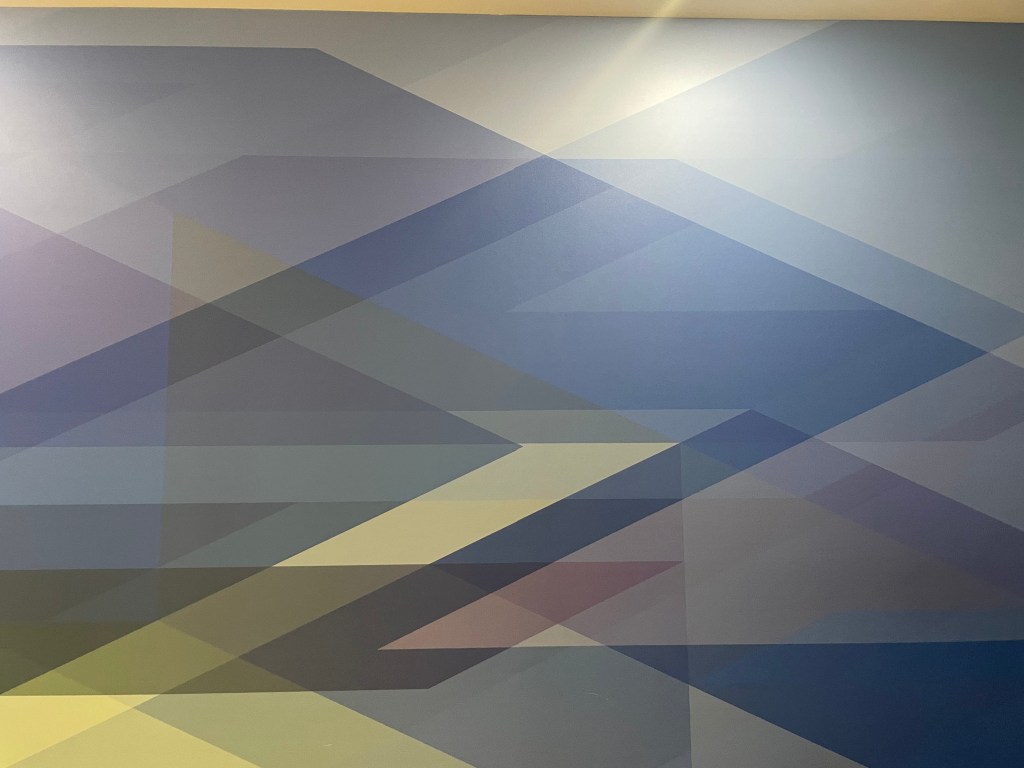 Various diamonds and rectangles in different translucent colours, overlapping to form other shapes where they intersect.